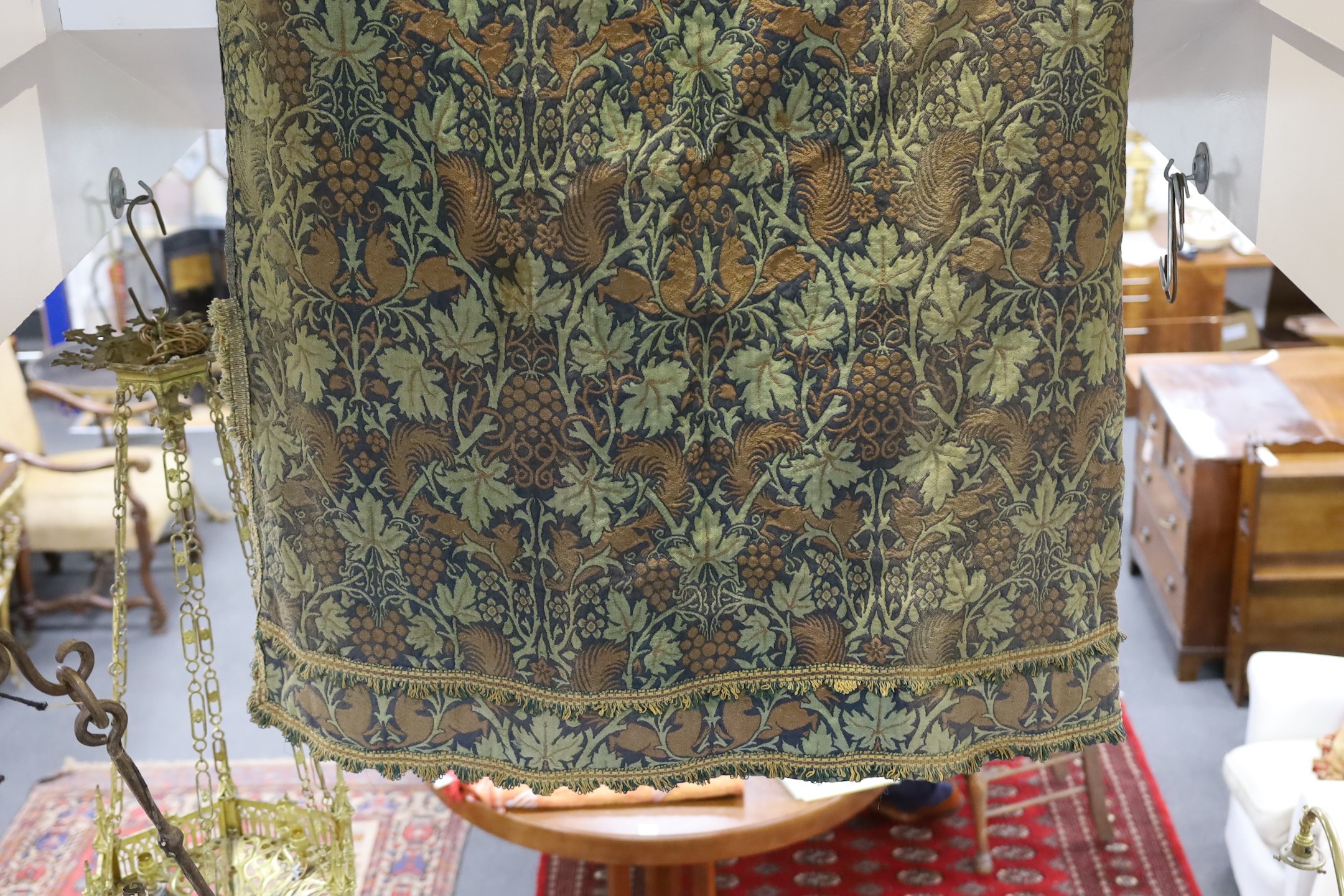 John Henry Dearle for Morris & Co. a pair of Squirrel design curtains, c.1890, hand loom woven wool at Merton Abbey, each with ornate braided edging and lining: 8ft 6ins. drop x 4ft wide each